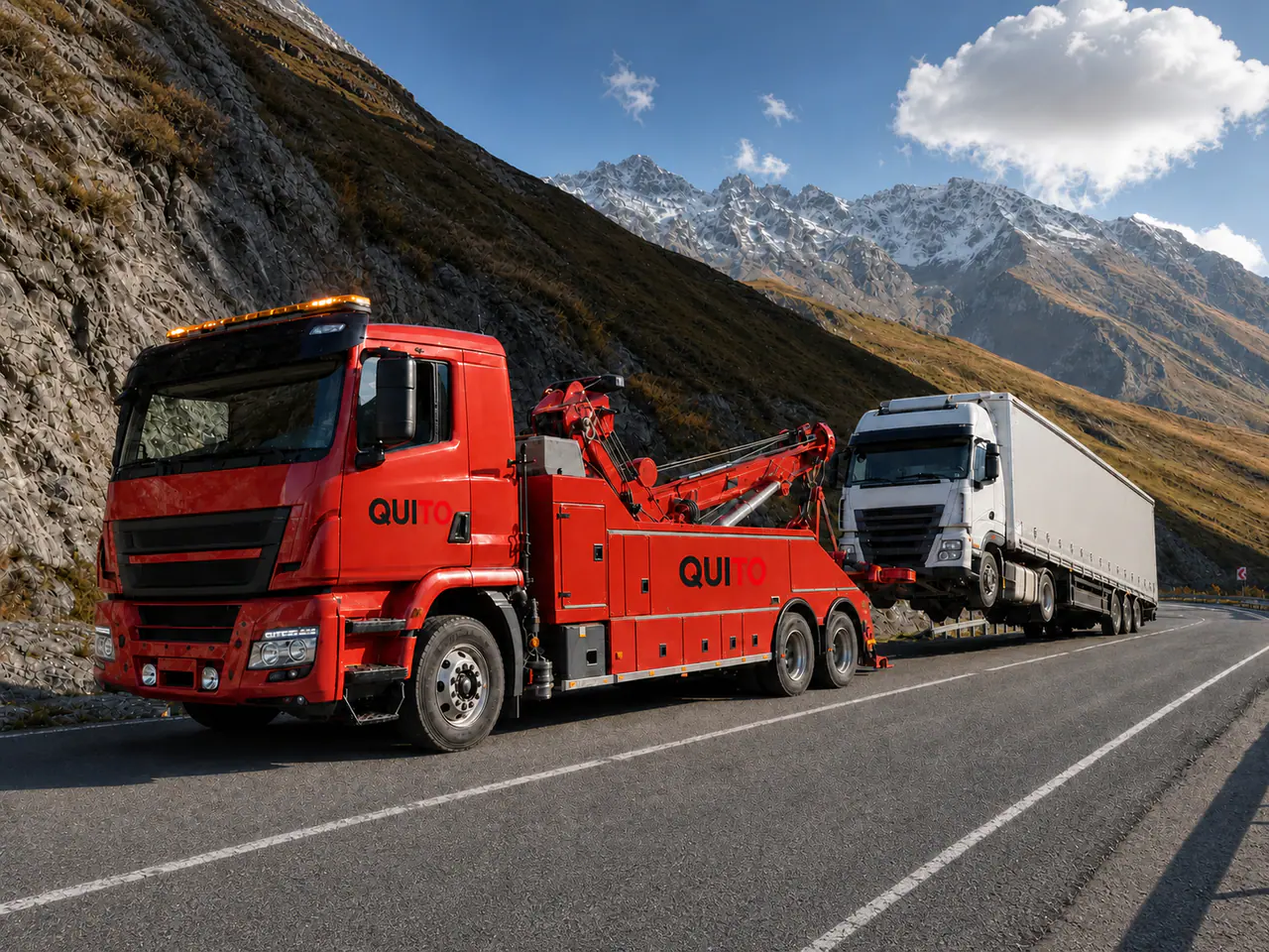 Quito-branded red European heavy recovery vehicle assisting an HGV in Georgia
